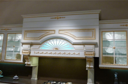 Kitchen cabinet decorated with carved wooden profiles